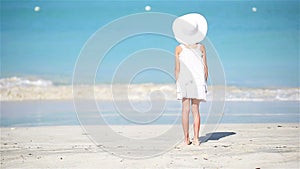 Little cute girl in white on the beach on caribbean vacation