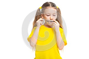 Little cute girl wipes glasses. Glasses fogged up, glass cleaned. Isolated on white background.