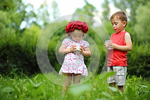 Little cute girl in wreath and boy hold milk in