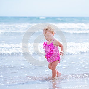 Little cute happy girl bathes in sea, Italy, outdoor