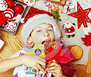 little cute kid in santas red hat with handmade gifts, toys vint