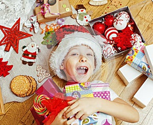 Little cute kid in santas red hat with handmade