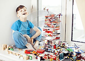 Little cute preschooler boy playing lego toys at home happy smiling, lifestyle children concept