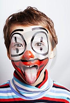 little cute real boy with facepaint like clown, pantomimic expre