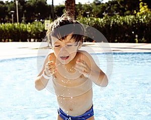 Little cute real boy in swimming pool close up smiling