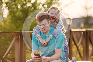 Little cute sister hugs older brother during their summer walk, brothers love, family relationships, relationship in fact,