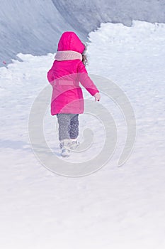 Little Cute sweet girl outdoor playing in winter snow park
