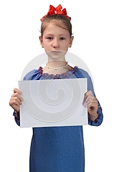 Little cute Ukrainian girl 11 years old posing in the studio on a white background. The child holds a blank white sheet