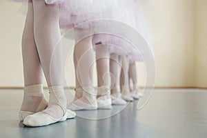 Little dancers legs in pointe shoes, making exercises