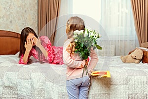 The little daughter congratulates her mother on her mother`s day