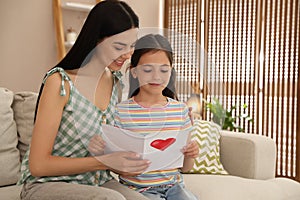 Little daughter congratulating mom at home. Happy Mother`s Day