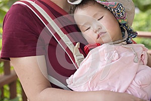 Little daughter lie on moms chest sleeping