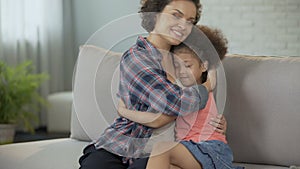 Little daughter tightly snuggling to beloved mother, full trust and affection