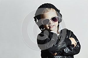 Little deejay. funny smiling boy in sunglasses and headphones