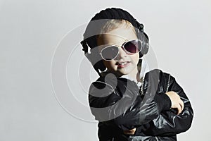 Little deejay. funny smiling boy in sunglasses and headphones photo