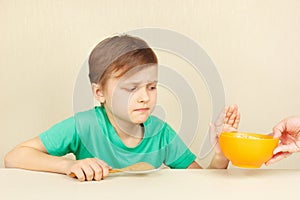 Little disaffected boy refuses to eat cereal