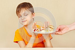 Little disaffected boy refuses to eat pasta with cutlet