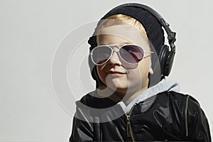 Little DJ. funny boy in sunglasses and headphones