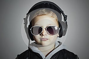 Little DJ. funny boy in sunglasses and headphones.child listening music in headphones. deejay