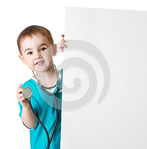 Little doctor kid behind blank banner isolated