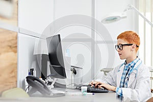 Little Doctor Using Computer in Office