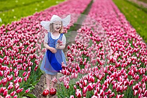 Little Dutch girl in tulip field