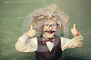 Little Einstein  against chalkboard.