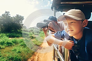 Little expiorer boy with his father on jeep safari