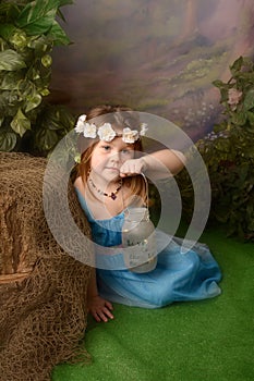 Little fairy in fairyland. Small girl with fairies in a jar.