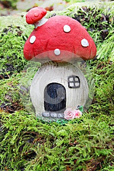 Little fairy mushroom house on a mossy forest background