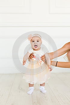 Little fairy. sweet ballerina with fluffy peach skirt and flower. Cute smiling baby girl on white studio backgroung. 6