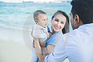 Little family happiness while vacation on the beach