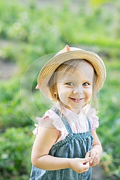 Little farmer child - lovely girl with picked vegetables