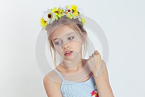 Little fashionista. Closeup beautiful little girl kid, wreath of yellow flowers floral head band on head light blue dress shirt