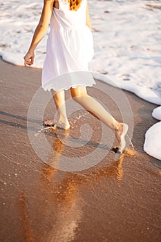 Little feet leave footprints on sandy shore of sea. walks on beach