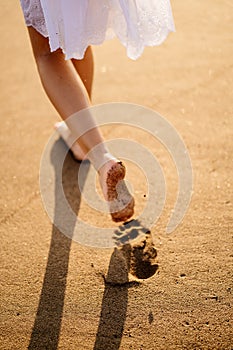 Little feet leave footprints on sandy shore of sea. walks on beach