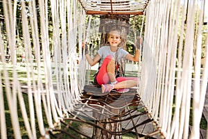 Little female climber in rope park, playground