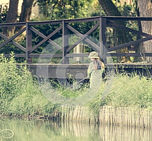 Little fisher girl holding a rod