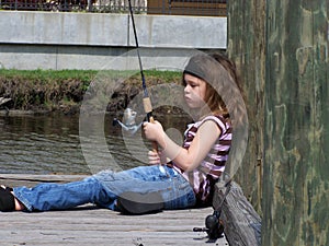 Little fishing girl daydreaming