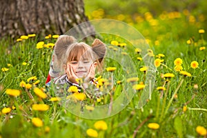 Little five-year girl lying in grass