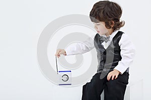 Little focused boy touches antenna of portable radio