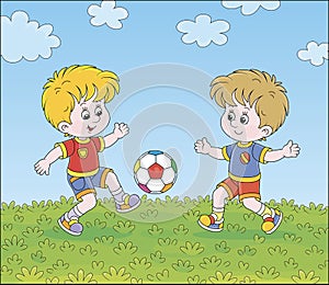 Little football players kicking a ball