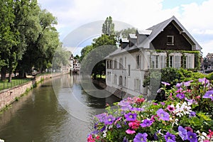 Little France, Strasbourg. The picturesque house in the middle of canal decorated with flower arrangements