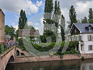 Little France, Strasbourg. The picturesque house in the middle of canal decorated with flower arrangements