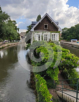 Little France, Strasbourg. The picturesque house in the middle of canal decorated with flower arrangements