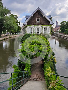 Little France, Strasbourg. The picturesque house in the middle of canal decorated with flower arrangements