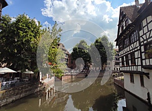 Little France, Strasbourg. Traditional houses decorated with flower arrangements, reflecting in the waters of the canal.