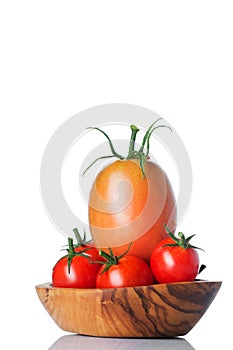 Little fresh tomatoes in a bowl. Studio Photo