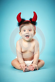 Little funny baby with devil horns