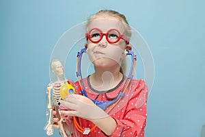 Little girl explore the structure of human body.